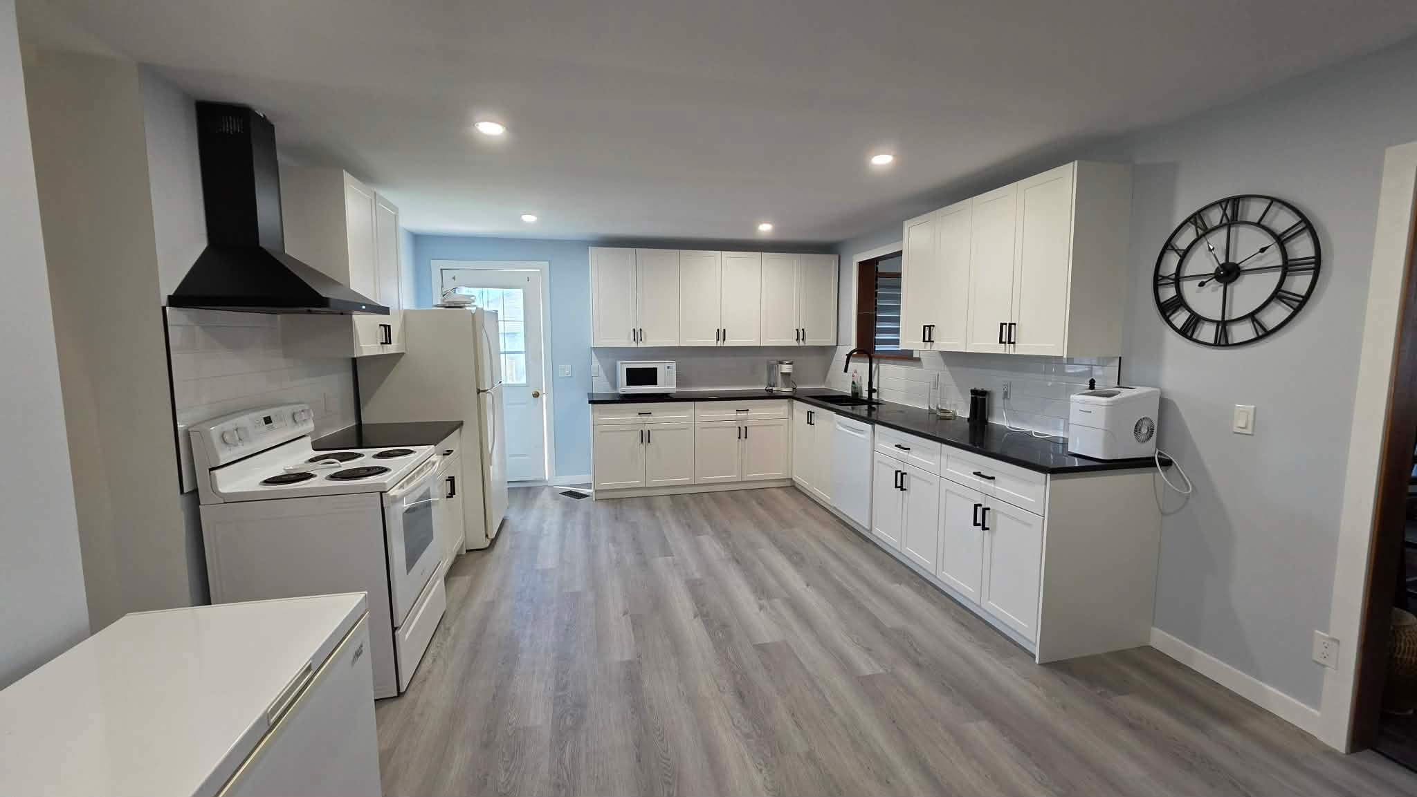 Modern White Shaker Kitchen with Black Quartz Countertops - After